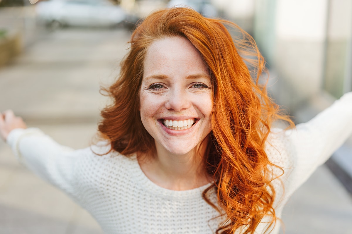 Glückliche, lachende junge Frau mit roten Haaren, Typberatung, Farb- und Stilberatung